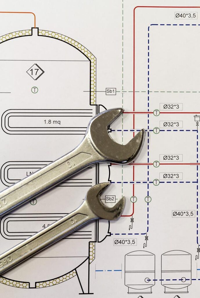 maintenance and service: wrench and project drawings with plumbing system